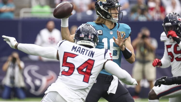 Sep 12, 2021; Houston, Texas, USA; Jacksonville Jaguars quarterback Trevor Lawrence (16) attempts a pass during the first quarter against the Houston Texans at NRG Stadium. Mandatory Credit: Troy Taormina-USA TODAY Sports