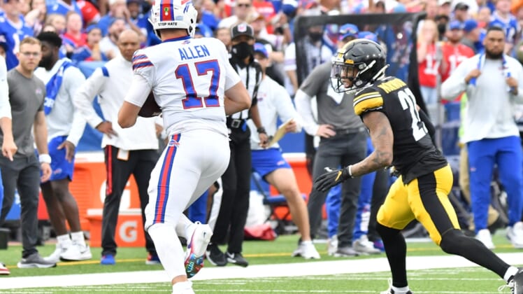 Sep 12, 2021; Orchard Park, New York, USA; Buffalo Bills quarterback Josh Allen (17) tries to outrun Pittsburgh Steelers cornerback Tre Norwood (21) in the first quarter of a game at Highmark Stadium. Mandatory Credit: Mark Konezny-USA TODAY Sports