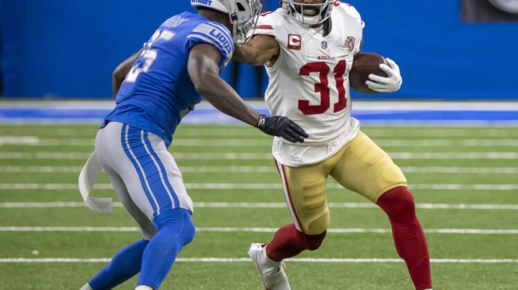 Sep 12, 2021; Detroit, Michigan, USA; San Francisco 49ers running back Raheem Mostert (31) puts a stiff arm to the helmet of Detroit Lions defensive back Will Harris (25) in the first quarter at Ford Field. Mandatory Credit: David Reginek-USA TODAY Sports