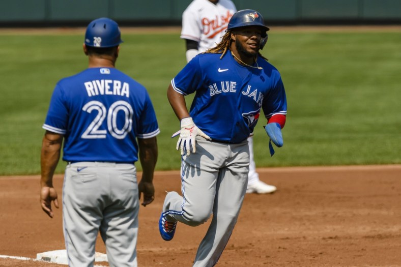 Sep 12, 2021; Baltimore, Maryland, USA;  Toronto Blue Jays designated hitter Vladimir Guerrero Jr. (27) runs to home plate on a home run by right fielder Teoscar Hernandez (not pictured) during the third inning at Oriole Park at Camden Yards. Mandatory Credit: James A. Pittman-USA TODAY Sports