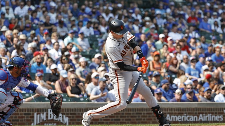 Sep 12, 2021; Chicago, Illinois, USA; San Francisco Giants second baseman Wilmer Flores (41) hits an RBI-single against the Chicago Cubs during the second inning at Wrigley Field. Mandatory Credit: Kamil Krzaczynski-USA TODAY Sports