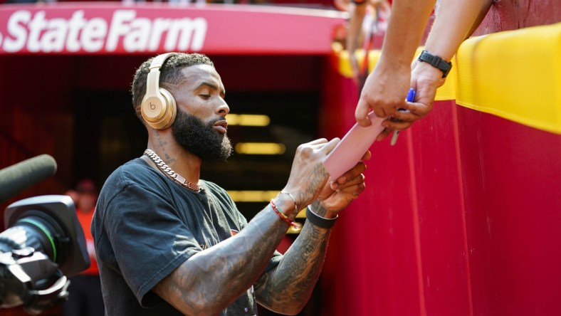 Sep 12, 2021; Kansas City, Missouri, USA; Cleveland Browns wide receiver Odell Beckham Jr. (13) signs autographs before the game against the Kansas City Chiefs at GEHA Field at Arrowhead Stadium. Mandatory Credit: Jay Biggerstaff-USA TODAY Sports