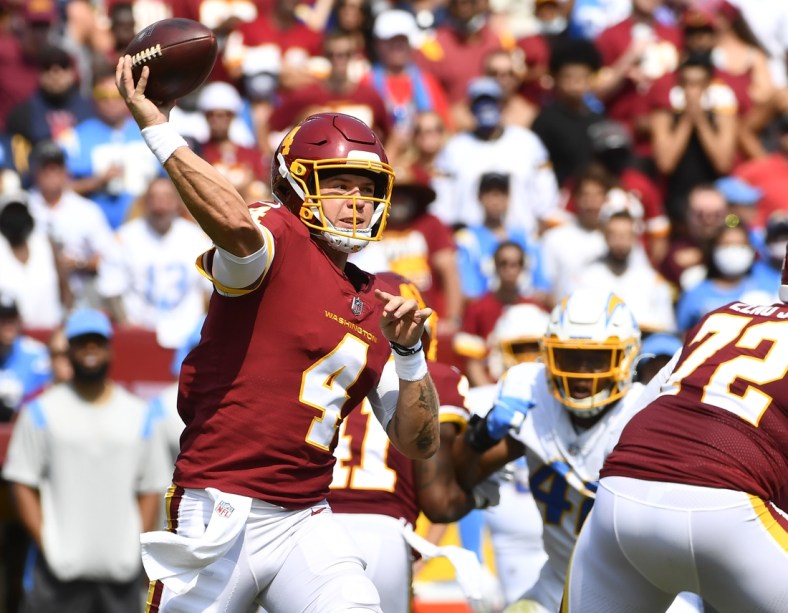 Sep 12, 2021; Landover, Maryland, USA; Washington Football Team quarterback Taylor Heinicke (4) attempts a pass against the Los Angeles Chargers during the second quarter at FedExField. Mandatory Credit: Brad Mills-USA TODAY Sports