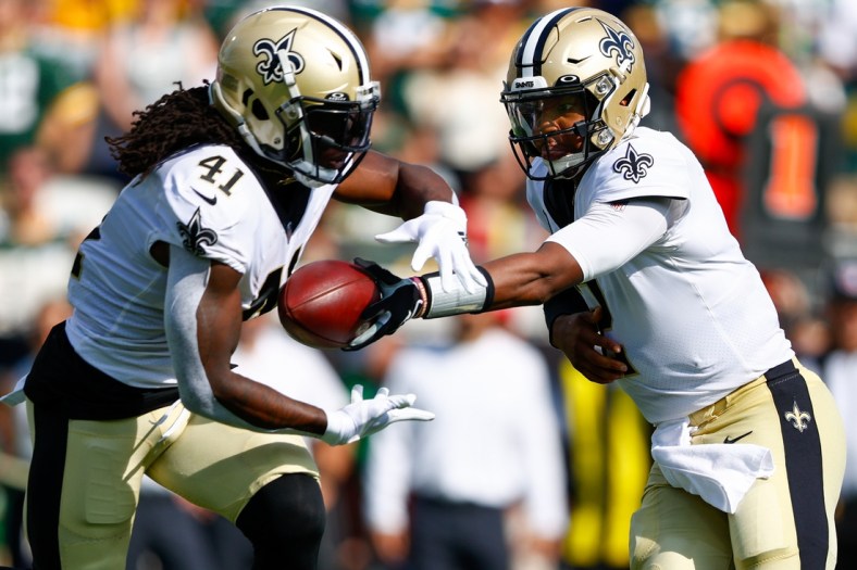 Sep 12, 2021; Jacksonville, Florida, USA;  New Orleans Saints quarterback Jameis Winston (2) hands off to  running back Alvin Kamara (41) in the first quarter against the Green Bay Packers at TIAA Bank Field. Mandatory Credit: Nathan Ray Seebeck-USA TODAY Sports