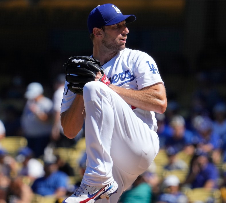 Sep 12, 2021; Los Angeles, California, USA; Los Angeles Dodgers starting pitcher Max Scherzer (31) winds up to throw a pitch in the fourth inning against the San Diego Padres at Dodger Stadium. Mandatory Credit: Robert Hanashiro-USA TODAY Sports