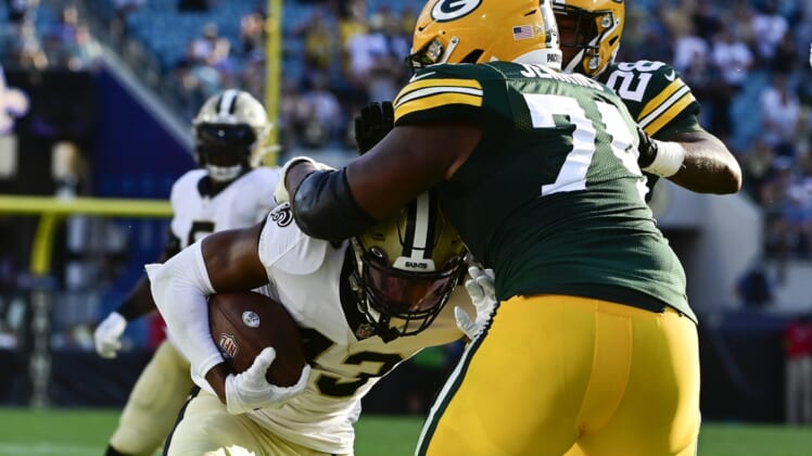 Sep 12, 2021; Jacksonville, Florida, USA;  Green Bay Packers guard Elgton Jenkins (74) tackles New Orleans Saints safety Marcus Williams (43) along the sideline during the third quarter at TIAA Bank Field. Mandatory Credit: Tommy Gilligan-USA TODAY Sports