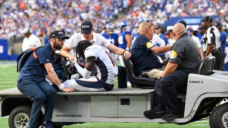 Sep 12, 2021; East Rutherford, New Jersey, USA;  Denver Broncos wide receiver Jerry Jeudy (10) is taken off the field after being injured in the game against the New York Giants during the second half at MetLife Stadium. Mandatory Credit: Dennis Schneidler-USA TODAY Sports