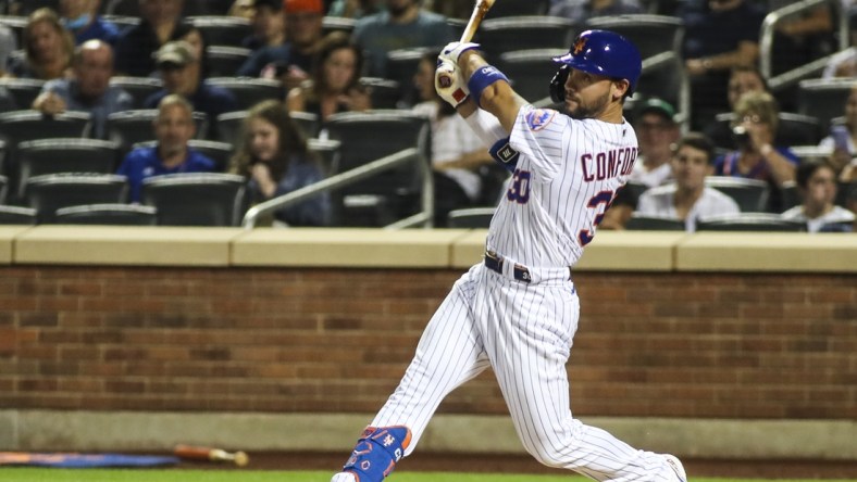 Sep 12, 2021; New York City, New York, USA; New York Mets right fielder Michael Conforto (30) hits an RBI single in the first inning against the New York Yankees at Citi Field. Mandatory Credit: Wendell Cruz-USA TODAY Sports