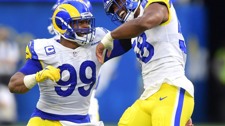 Sep 12, 2021; Inglewood, California, USA;  Los Angeles Rams defensive end Aaron Donald (99) celebrates with linebacker Justin Hollins (58) after he forced a fumble against the Chicago Bears in the first half of the game at SoFi Stadium. Mandatory Credit: Jayne Kamin-Oncea-USA TODAY Sports