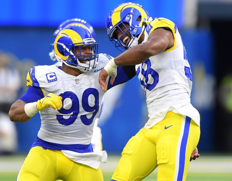 Sep 12, 2021; Inglewood, California, USA;  Los Angeles Rams defensive end Aaron Donald (99) celebrates with linebacker Justin Hollins (58) after he forced a fumble against the Chicago Bears in the first half of the game at SoFi Stadium. Mandatory Credit: Jayne Kamin-Oncea-USA TODAY Sports