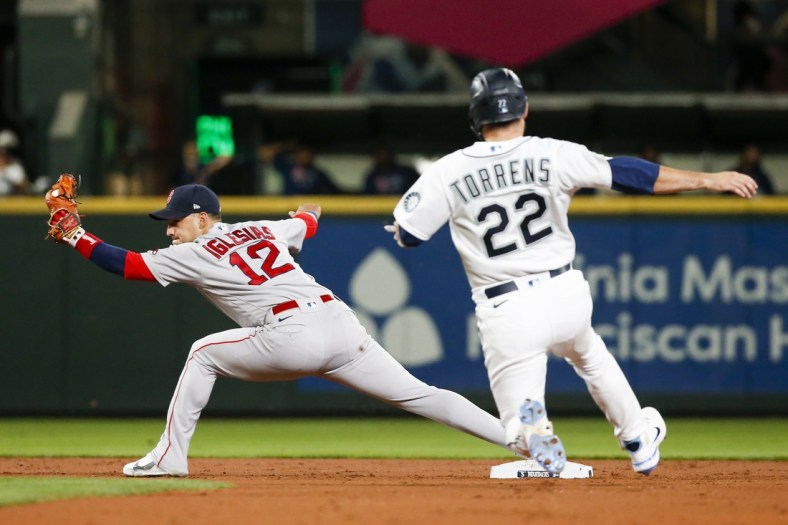 Sep 13, 2021; Seattle, Washington, USA; Boston Red Sox second baseman Jose Iglesias (12) reaches for a force out against the Seattle Mariners during the second inning at T-Mobile Park. Mandatory Credit: Joe Nicholson-USA TODAY Sports