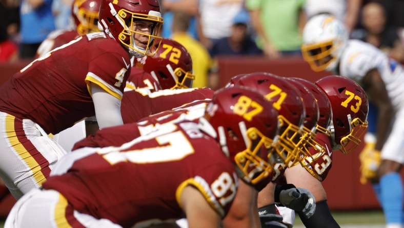 Sep 12, 2021; Landover, Maryland, USA; Washington Football Team quarterback Taylor Heinicke (4) lines up under center Washington Football Team center Chase Roullier (73) against the Los Angeles Chargers at FedExField. Mandatory Credit: Geoff Burke-USA TODAY Sports