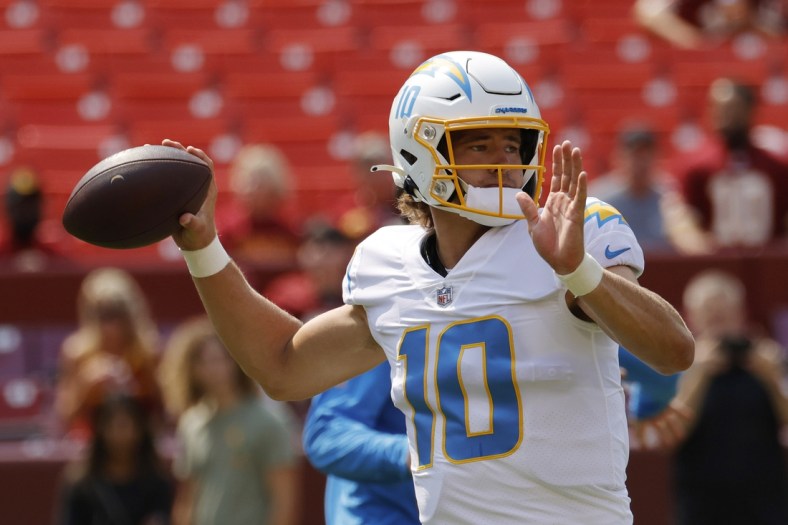 Sep 12, 2021; Landover, Maryland, USA; Los Angeles Chargers quarterback Justin Herbert (10) passes the ball during warmups prior to the Chargers' game against the Washington Football Team at FedExField. Mandatory Credit: Geoff Burke-USA TODAY Sports
