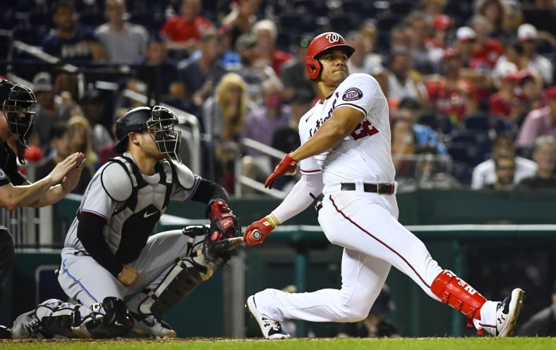 Sep 14, 2021; Washington, District of Columbia, USA; Washington Nationals right fielder Juan Soto (22) hits an RBI single against the Miami Marlins during the third inning at Nationals Park. Mandatory Credit: Brad Mills-USA TODAY Sports