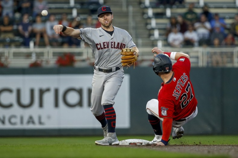 Sep 14, 2021; Minneapolis, Minnesota, USA; Cleveland Indians second baseman Owen Miller (6) forces out Minnesota Twins catcher Ryan Jeffers (27) and turns a double play in the second inning at Target Field. Mandatory Credit: Bruce Kluckhohn-USA TODAY Sports