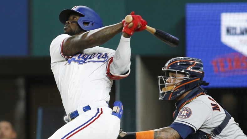 Sep 14, 2021; Arlington, Texas, USA; Texas Rangers right fielder Adolis Garcia (53) hits a home run in the third inning against the Houston Astros at Globe Life Field. Mandatory Credit: Tim Heitman-USA TODAY Sports