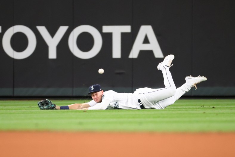Sep 14, 2021; Seattle, Washington, USA;  Seattle Mariners center fielder Jarred Kelenic (10) is unable to make the catch for a hit off the bat of Boston Red Sox shortstop Jose Iglesias (12) in the fifth inning at T-Mobile Park. Mandatory Credit: Abbie Parr-USA TODAY Sports
