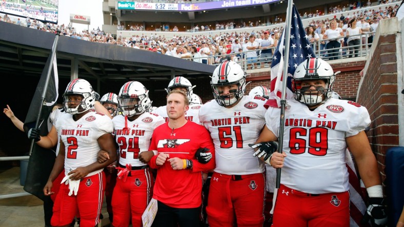 Sep 11, 2021; Oxford, Mississippi, USA; Austin Peay Governors head coach Scotty Walden (middle), offensive linemen Garrett Bell (57), wide receiver Trey Goodman (24), offensive linemen Colby McKee (51) and offensive linemen Michael Treadwell (69) prepare to run out of the tunnel before their game against the Mississippi Rebels at Vaught-Hemingway Stadium. Mandatory Credit: Petre Thomas-USA TODAY Sports