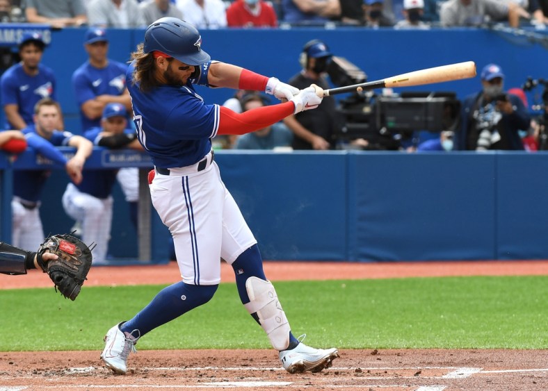 Sep 15, 2021; Toronto, Ontario, CAN;  Toronto Blue Jays shortstop Bo Bichette (11) hits a three run home run against Tampa Bay Rays in the first inning at Rogers Centre. Mandatory Credit: Dan Hamilton-USA TODAY Sports