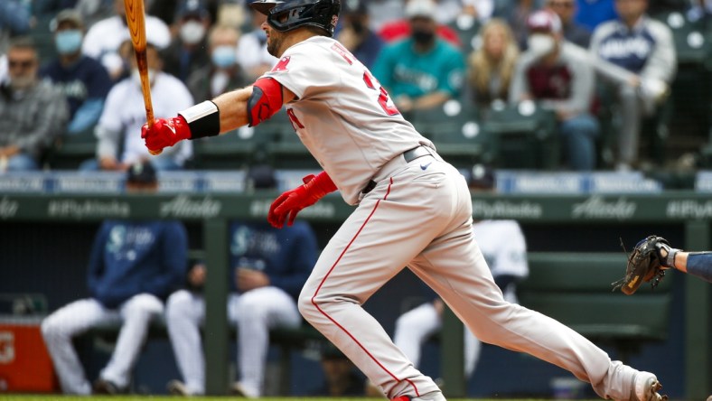 Sep 15, 2021; Seattle, Washington, USA; Boston Red Sox catcher Kevin Plawecki (25) hits an RBI-fielders choice against the Seattle Mariners during the second inning at T-Mobile Park. Mandatory Credit: Joe Nicholson-USA TODAY Sports