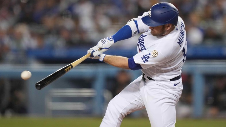 Sep 15, 2021; Los Angeles, California, USA; Los Angeles Dodgers first baseman Max Muncy (13) follows through on a single in the third inning against the Arizona Diamondbacks at Dodger Stadium. Mandatory Credit: Kirby Lee-USA TODAY Sports