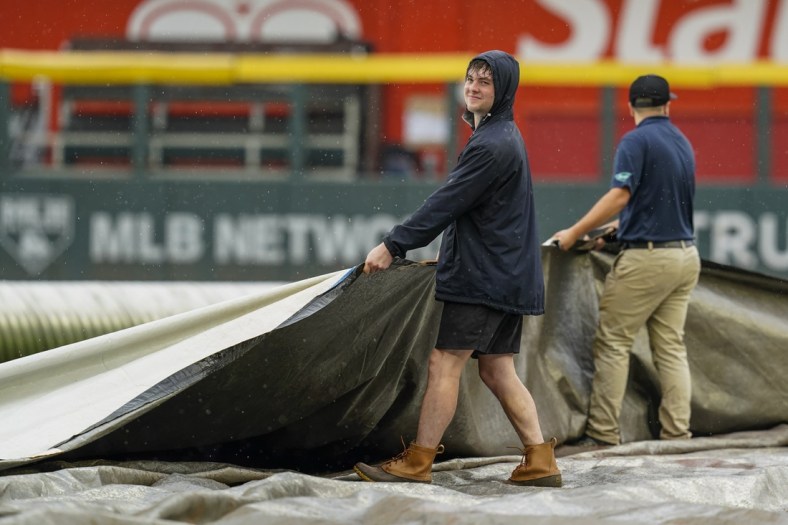 Sep 16, 2021; Cumberland, Georgia, USA; Atlanta Braves grounds crew works on the field during a rain delay prior to the start of the game against the Colorado Rockies at Truist Park. Mandatory Credit: Dale Zanine-USA TODAY Sports