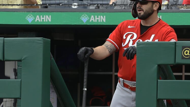 Sep 16, 2021; Pittsburgh, Pennsylvania, USA;  Cincinnati Reds third baseman Mike Moustakas (9) looks on from the dugout before batting against the Pittsburgh Pirates during the first inning at PNC Park. Mandatory Credit: Charles LeClaire-USA TODAY Sports