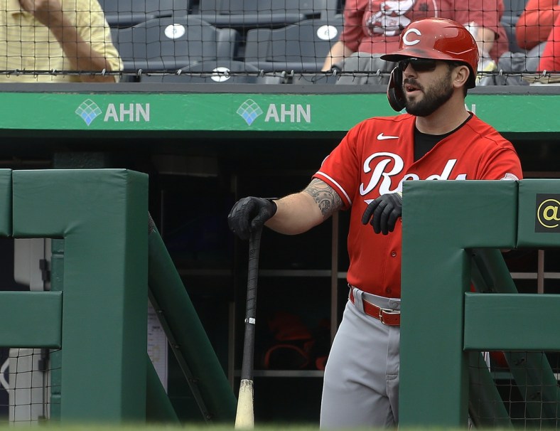 Sep 16, 2021; Pittsburgh, Pennsylvania, USA;  Cincinnati Reds third baseman Mike Moustakas (9) looks on from the dugout before batting against the Pittsburgh Pirates during the first inning at PNC Park. Mandatory Credit: Charles LeClaire-USA TODAY Sports