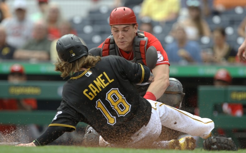 Sep 16, 2021; Pittsburgh, Pennsylvania, USA;  Cincinnati Reds catcher Tyler Stephenson (37) tags Pittsburgh Pirates left fielder Ben Gamel (18) out at home plate attempting to score during the second inning at PNC Park. Mandatory Credit: Charles LeClaire-USA TODAY Sports