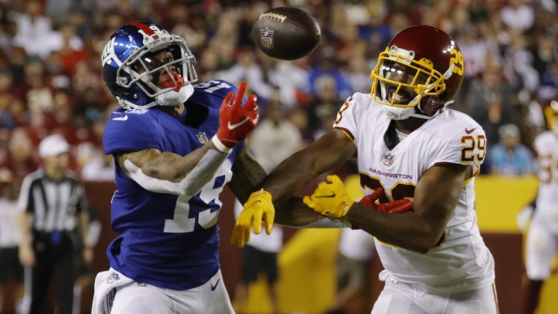 Sep 16, 2021; Landover, Maryland, USA; New York Giants wide receiver Kenny Golladay (19) attempts to make a catch as Washington Football Team cornerback Kendall Fuller (29) defends in the third quarter at FedExField. Mandatory Credit: Geoff Burke-USA TODAY Sports