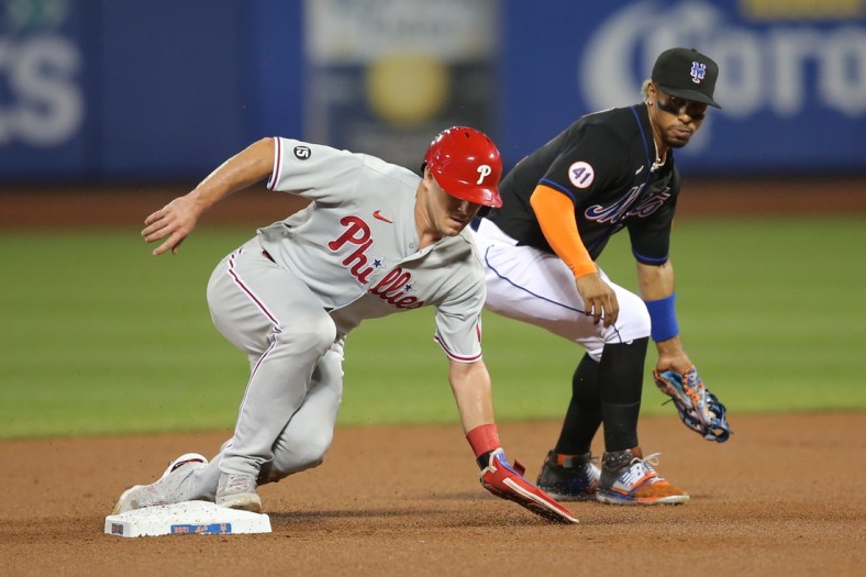 Sep 17, 2021; New York City, New York, USA; Philadelphia Phillies catcher J.T. Realmuto (10) steals second base ahead of a tag by New York Mets shortstop Francisco Lindor (12) during the second inning at Citi Field. Mandatory Credit: Brad Penner-USA TODAY Sports