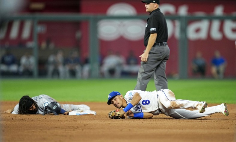 Sep 17, 2021; Kansas City, Missouri, USA; Seattle Mariners shortstop J.P. Crawford (left) reacts after he is caught stealing by Kansas City Royals shortstop Nicky Lopez (8) during the third inning at Kauffman Stadium. Mandatory Credit: Jay Biggerstaff-USA TODAY Sports