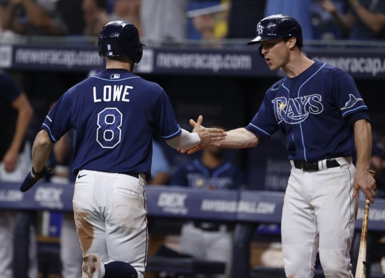 Sep 17, 2021; St. Petersburg, Florida, USA; Tampa Bay Rays second baseman Brandon Lowe (8) is congratulated by Tampa Bay Rays third baseman Joey Wendle (18) as he scores a run during the ninth inning against the Detroit Tigers  at Tropicana Field. Mandatory Credit: Kim Klement-USA TODAY Sports