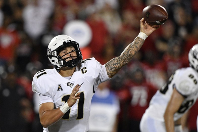 Sep 17, 2021; Louisville, Kentucky, USA;  UCF Knights quarterback Dillon Gabriel (11) throws a pass against the Louisville Cardinals during the second half at Cardinal Stadium. Louisville defeated Central Florida 42-35. Mandatory Credit: Jamie Rhodes-USA TODAY Sports