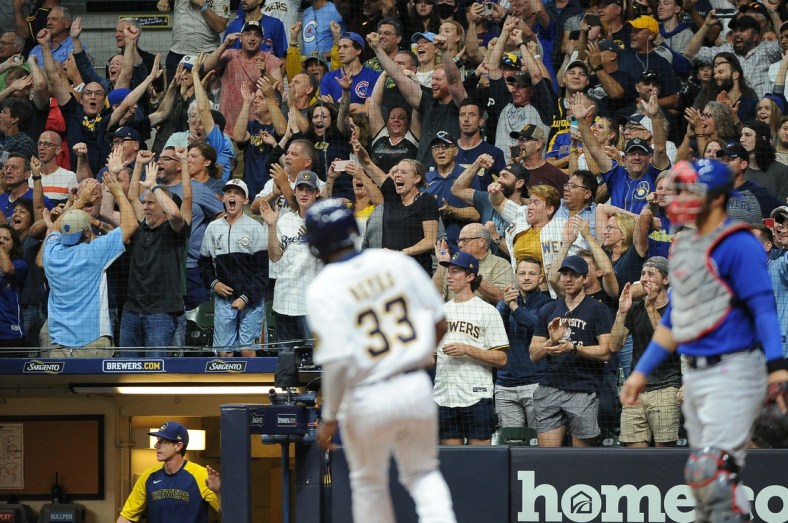 Sep 17, 2021; Milwaukee, Wisconsin, USA; Milwaukee Brewers left fielder Pablo Reyes (33) scores a run as fans cheer in the stands in the eighth inning against the Chicago Cubs at American Family Field. Mandatory Credit: Michael McLoone-USA TODAY Sports