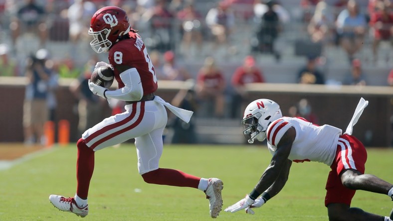 Oklahoma's Michael Woods II (8) catches the ball in front of of Nebraska's Cam Taylor-Britt (5) during a college football game between the University of Oklahoma Sooners (OU) and the Nebraska Cornhuskers at Gaylord Family-Oklahoma Memorial Stadium in Norman, Okla., Saturday, Sept. 18, 2021.

Lx14541