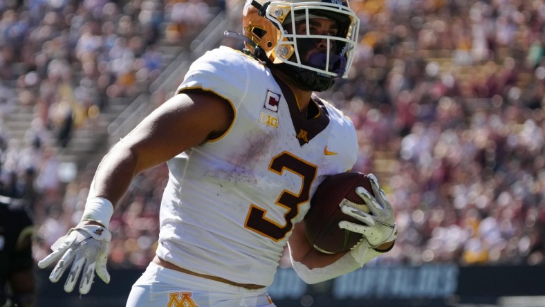 Sep 18, 2021; Boulder, Colorado, USA; Minnesota Golden Gophers running back Treyson Potts (3) carries for a touchdown in the first quarter at Folsom Field. Mandatory Credit: Ron Chenoy-USA TODAY Sports