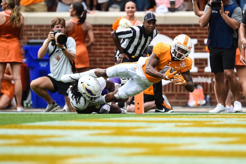 Sep 18, 2021; Knoxville, Tennessee, USA; Tennessee Volunteers wide receiver Velus Jones Jr. (1) dives over Tennessee Tech Golden Eagles defensive back Jamaal Boyd (8) for a touchdown during the first half at Neyland Stadium. Mandatory Credit: Bryan Lynn-USA TODAY Sports