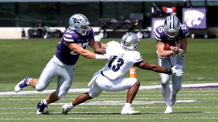Sep 18, 2021; Manhattan, Kansas, USA; Nevada Wolf Pack defensive back Jordan Lee (13) tries to break away from the block by Kansas State Wildcats tight end Nick Lenners (87) to tackle Wildcats quarterback Will Howard (15) during the first quarter of a game at Bill Snyder Family Football Stadium. Mandatory Credit: Scott Sewell-USA TODAY Sports
