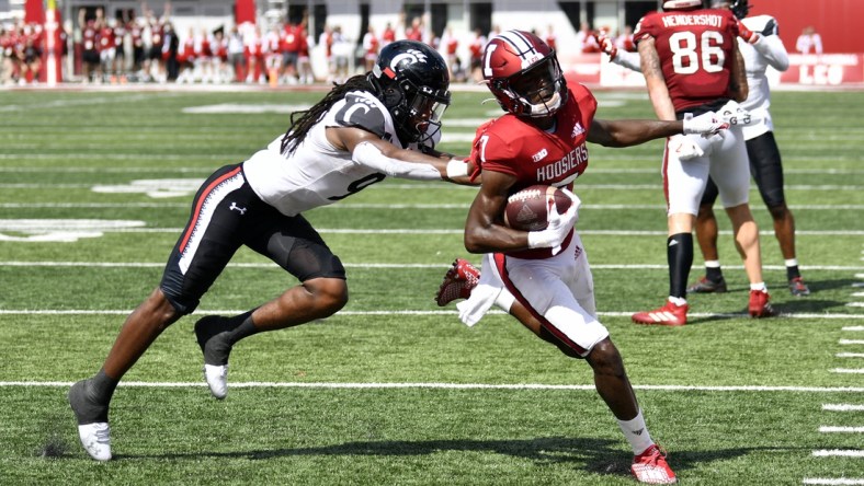 Sep 18, 2021; Bloomington, Indiana, USA; Indiana Hoosiers wide receiver D.J. Matthews Jr. (7) runs the ball into the end zone for a touchdown against Cincinnati Bearcats cornerback Arquon Bush (9) during the second half at Memorial Stadium. Bearcats won 38-24. Mandatory Credit: Marc Lebryk-USA TODAY Sports