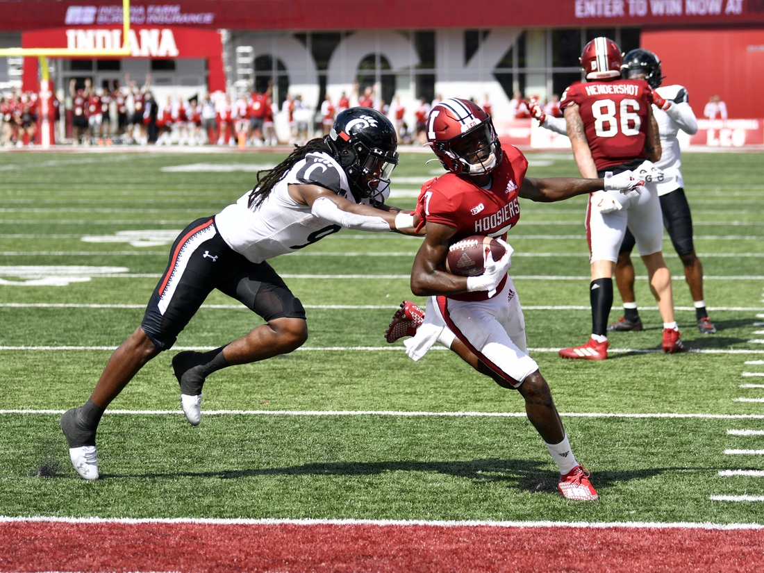 Sep 18, 2021; Bloomington, Indiana, USA; Indiana Hoosiers wide receiver D.J. Matthews Jr. (7) runs the ball into the end zone for a touchdown against Cincinnati Bearcats cornerback Arquon Bush (9) during the second half at Memorial Stadium. Bearcats won 38-24. Mandatory Credit: Marc Lebryk-USA TODAY Sports