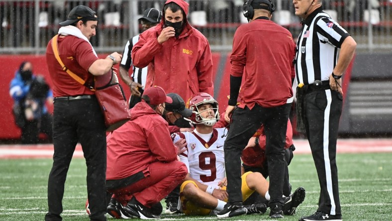 Sep 18, 2021; Pullman, Washington, USA; USC Trojans quarterback Kedon Slovis (9) is checked out by medical staff during a game against the Washington State Cougars in the first half at Gesa Field at Martin Stadium. Mandatory Credit: James Snook-USA TODAY Sports