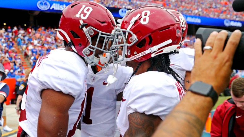 Sep 18, 2021; Gainesville, Florida, USA; Alabama Crimson Tide tight end Jahleel Billingsley (19) celebrates with wide receiver John Metchie III (8) after scoring a touchdown during the first quarter against the Florida Gators celebrates at Ben Hill Griffin Stadium. Mandatory Credit: Mark J. Rebilas-USA TODAY Sports