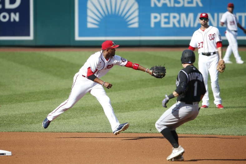 Sep 18, 2021; Washington, District of Columbia, USA; Washington Nationals shortstop Alcides Escobar (3) reaches for the ball as Colorado Rockies center baseman Garrett Hampson (1) runs to second base in the second inning at Nationals Park. Mandatory Credit: Amber Searls-USA TODAY Sports
