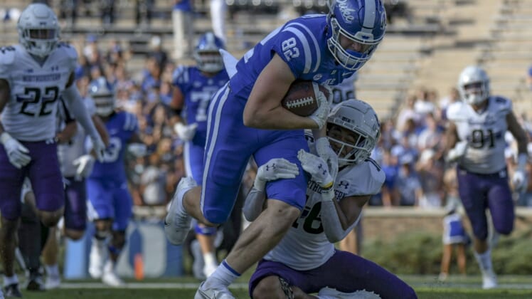 Sep 18, 2021; Durham, North Carolina, USA; Duke Blue Devils tight end Cole Finney (82) is tackled by Northwestern Wildcats safety Brandon Joseph (16) during the second quarter at Wallace Wade Stadium. Mandatory Credit: William Howard-USA TODAY Sports