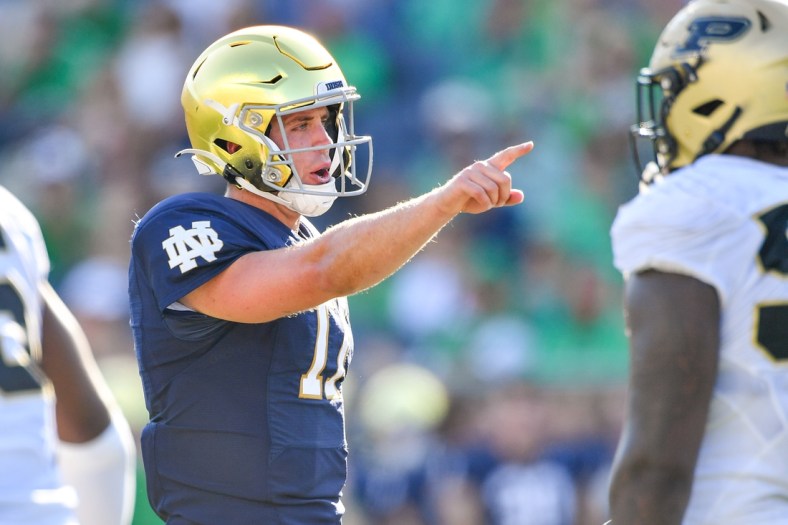 Sep 18, 2021; South Bend, Indiana, USA; Notre Dame Fighting Irish quarterback Jack Coan (17) signals in the fourth quarter against the Purdue Boilermakers at Notre Dame Stadium. Mandatory Credit: Matt Cashore-USA TODAY Sports
