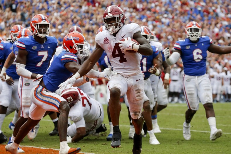 Sep 18, 2021; Gainesville, Florida, USA;  Alabama running back Brian Robinson Jr. (4) runs around Florida defenders for a touchdown at Ben Hill Griffin Stadium. Alabama defeated Florida 31-29. Mandatory Credit: Gary Cosby-USA TODAY Sports
