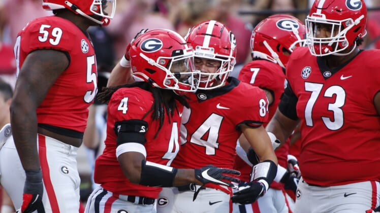 Sep 18, 2021; Athens, Georgia, USA; Georgia Bulldogs running back James Cook (4) celebrates with his teammates after scoring a touchdown against the South Carolina Gamecocks during the first half at Sanford Stadium. Mandatory Credit: Joshua L. Jones/Athens Banner-Herald via USA TODAY NETWORK