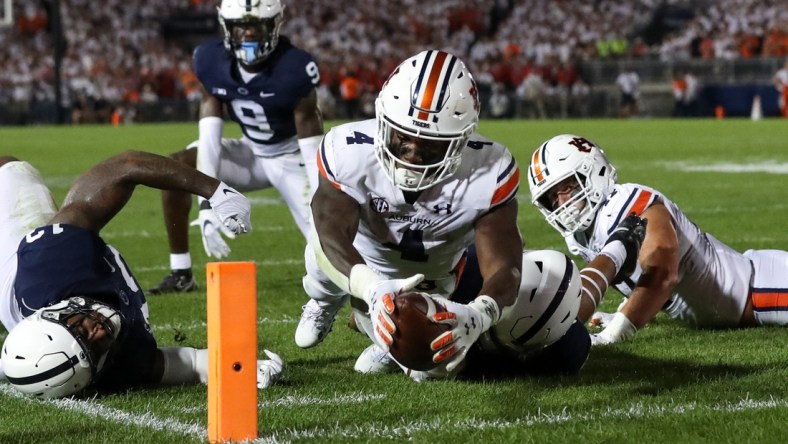 Sep 18, 2021; University Park, Pennsylvania, USA; Auburn Tigers running back Tank Bigsby (4) dives with the ball towards the end zone pylon for a touchdown during the third quarter against the Penn State Nittany Lions at Beaver Stadium. Penn State defeated Auburn 28-20. Mandatory Credit: Matthew OHaren-USA TODAY Sports