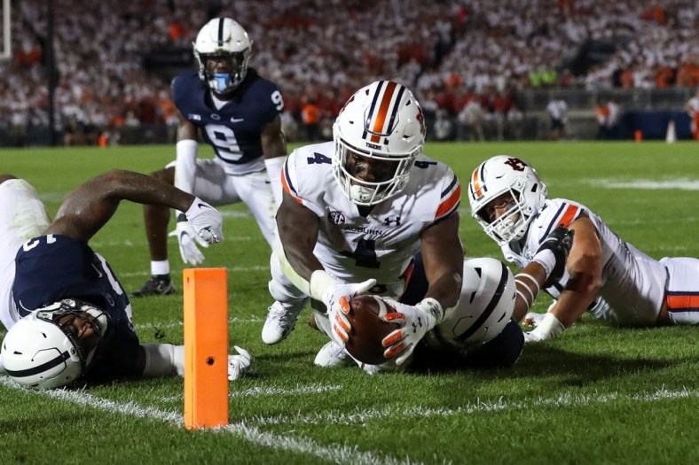 Sep 18, 2021; University Park, Pennsylvania, USA; Auburn Tigers running back Tank Bigsby (4) dives with the ball towards the end zone pylon for a touchdown during the third quarter against the Penn State Nittany Lions at Beaver Stadium. Penn State defeated Auburn 28-20. Mandatory Credit: Matthew OHaren-USA TODAY Sports